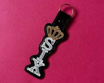 SIX inspirierter Schlüsselanhänger aus Kunstleder mit Stickerei und Applikation, unter dem Thema Musicals/Broadway