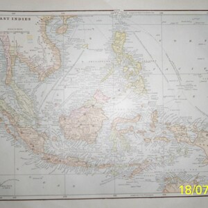 May include: An antique map of the East Indies, showing the islands of Southeast Asia, including the Philippines, Borneo, Sumatra, Java, and New Guinea. The map is printed in black and white with some color accents, and includes detailed geographic features and place names.