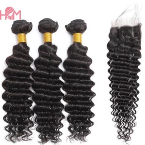 May include: Three bundles of black human hair extensions in a deep wave pattern, with a matching closure. The hair is tied with a gold elastic band.