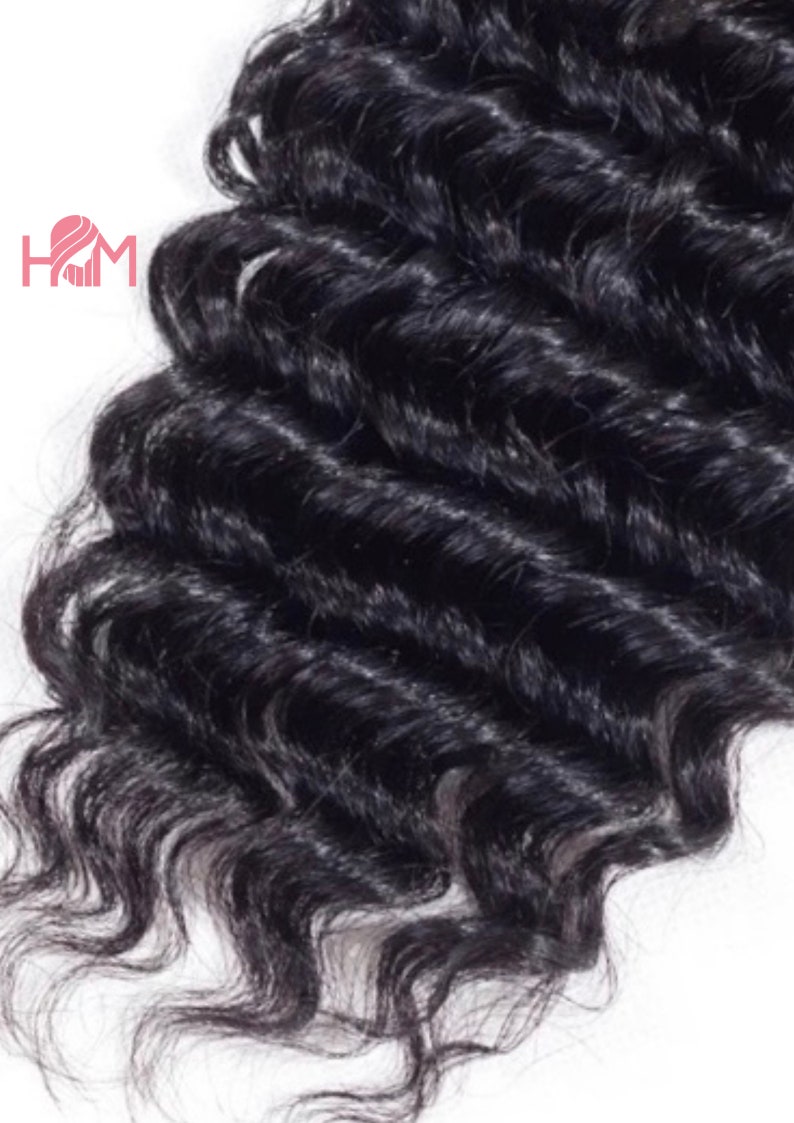 May include: A close-up of a black curly human hair weave. The hair is thick and full, with a natural, loose curl pattern.