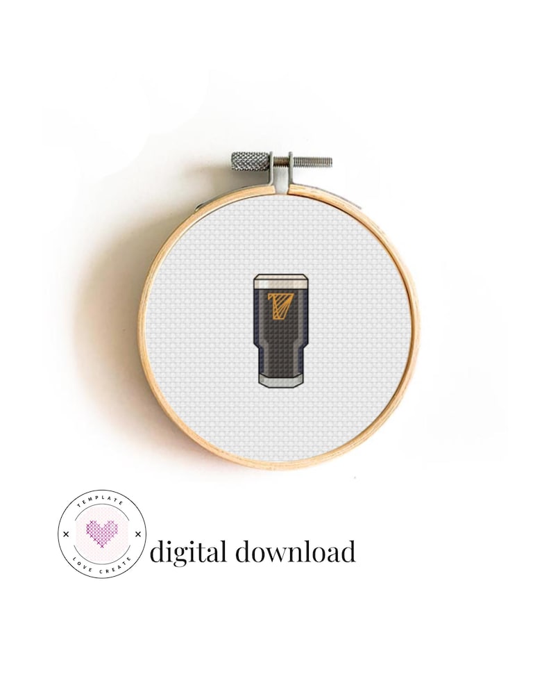 May include: A cross-stitch embroidery hoop featuring a pint of stout with a gold logo. The design is set against a white background and is held in a wooden embroidery hoop. The text "digital download" is also included.