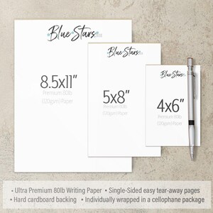 three different sizes of Blue Stars stationery, including 8.5x11", 5x8", and 4x6" paper, as well as a pen. The stationery is labeled as "Ultra Premium 80lb Writing Paper" and "Single-Sided easy tear-away pages". The stationery is also described as "Hard cardboard backing" and "Individually wrapped in a cellophane package".