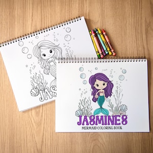 May include: Two spiral-bound mermaid coloring books with a set of crayons. One book features a black and white mermaid illustration, while the other has a purple-haired mermaid with the text "JASMINE'S MERMAID COLORING BOOK".
