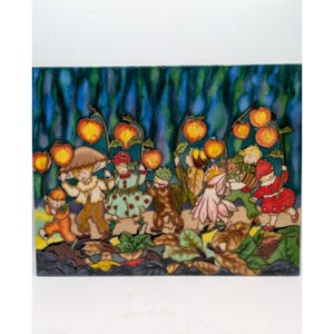 May include: A rectangular ceramic tile featuring a colorful illustration of several small figures walking through a forest. The figures carry glowing orange lanterns on stems against a dark blue background, with brown and green foliage below.