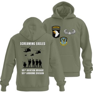 May include: Olive green hoodie featuring the text "Screaming Eagles" and silhouettes of helicopters and soldiers. The back of the hoodie displays the text "101st Aviation Brigade" and "101st Airborne Division". The front has patches with an eagle and the word "Airborne".