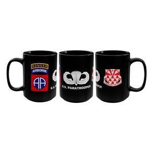 May include: Three black ceramic mugs with different military insignia designs. The first mug features a red, white, and blue patch with the text "Ranger Airborne" and a stylized "AA" symbol. The second mug features a white parachute with wings and the text "U.S. Paratrooper". The third mug features a red and white shield with the text "I Maintain the Right".