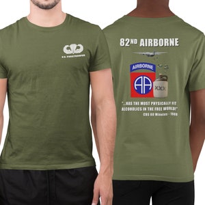 May include: A green t-shirt with a white paratrooper patch on the left chest and a graphic on the back that says "82nd Airborne" with a red, white, and blue patch, a cartoon airplane, and a jug with "XXX" on it. The graphic also includes the text "...HAS THE MOST PHYSICALLY FIT ALCOHOLICS IN THE FREE WORLD!" and "CBS 60 Minutes - 1988".