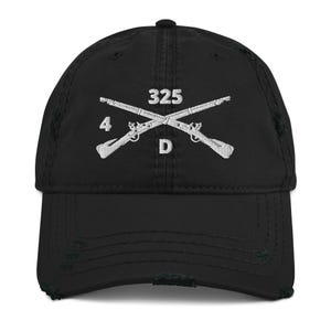 May include: Black distressed baseball cap with white embroidered crossed rifles and the numbers "325", "4", and the letter "D". The cap has a pre-curved bill and a distressed finish.
