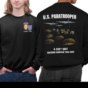 May include: Black sweatshirt with a white print on the front and back. The front print says "Airborne" and "4-325th Air". The back print says "U.S. Paratrooper" with a graphic of paratroopers jumping from airplanes and the text "4-325th ABCT Southern European Task Force".