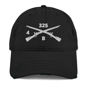 May include: Black distressed baseball cap with a white embroidered design of crossed rifles, the number 325, and the letters 4B.