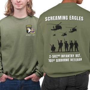 May include: Green sweatshirt with a white print on the front and back. The front print says "Airborne" and "2-502nd INF". The back print says "Screaming Eagles", "2-502nd Infantry Rgt.", and "101st Airborne Veteran".