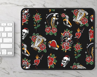 May include: A rectangular mouse pad with a black background featuring a repeating pattern of traditional tattoo-style illustrations including skulls, red roses, coffins with the text "PERMANENT VACATION," daggers through hearts, and grim reapers.