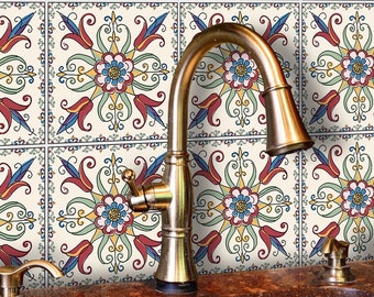May include: Decorative ceramic tiles with a floral design in red, blue, yellow, and green. The tiles are arranged in a grid pattern and are installed as a backsplash behind a kitchen sink with a brass faucet.