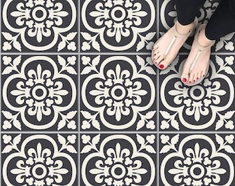 May include: Black and white patterned floor tiles with a repeating floral design. The tiles are arranged in a grid pattern.