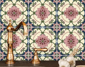 May include: A kitchen sink with a gold faucet and a tiled backsplash featuring a repeating pattern of pink and green floral designs.  There are three heads of garlic on the counter.