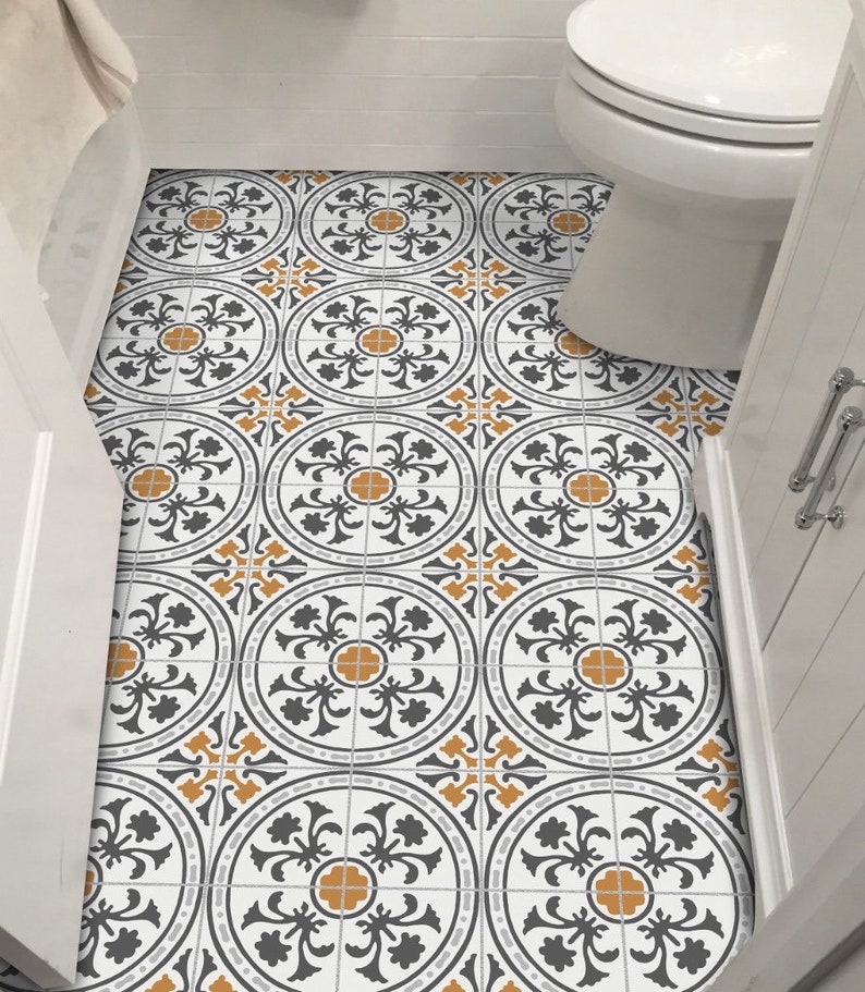 May include: A bathroom floor with black and white patterned tiles with a yellow accent. The tiles are arranged in a repeating pattern.
