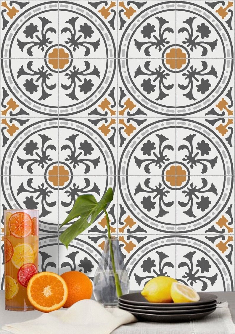 May include: A set of six decorative ceramic tiles with a white background, black floral pattern, and orange accents. The tiles are arranged in a grid pattern and feature a repeating design.