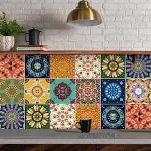 May include: A kitchen backsplash featuring a grid of eighteen square tiles, each displaying a unique, colorful mandala-inspired geometric pattern in shades of blue, orange, yellow, green, and red, arranged in three horizontal rows of six tiles.