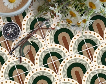 May include: A pattern of green, brown, and white arches with white polka dots on a cream background. The pattern is repeated on multiple tiles. A compass, a pair of glasses, and a cup of coffee are on top of the tiles. A bouquet of white daisies is in the upper right corner of the image.