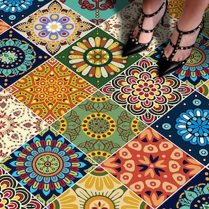 May include: A collection of square floor tiles featuring a variety of colorful mandala patterns in shades of blue, orange, yellow, green, and cream. Each tile displays a unique geometric floral design arranged in a repeating grid pattern.