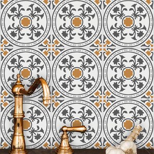 May include: A kitchen sink with gold faucets and a tiled backsplash featuring a repeating pattern of gray and orange floral designs.