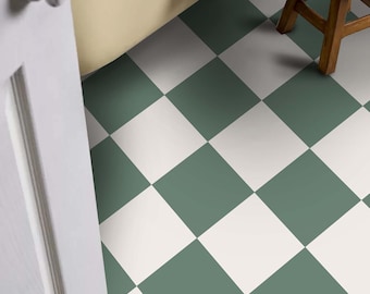 May include: A bathroom with a white door, a white bathtub, and a green and white checkered floor. A wooden stool with a pink throw blanket and a book on top sits in the corner of the room.