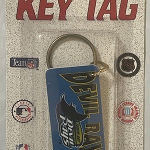 May include: A blue and yellow key chain with the Tampa Bay Devil Rays logo. The keychain is attached to a gold key ring. The packaging says "Key Tag" and "Tag Express".