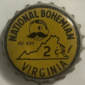 May include: A yellow and black bottle cap with the text "National Bohemian" and "Virginia" around the edge. The center of the cap features a cartoon man with a mustache and the text "Mr. Boh" and "2c".