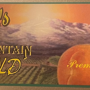 May include: A vintage label for Talbot's Mountain Gold Premium Palisade Peaches. The label features a mountain scene with a sunset sky and the text "Classic Series 1949".