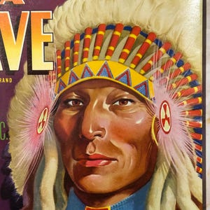 May include: A vintage illustration of a Native American man wearing a headdress with red, yellow, and blue feathers. The headdress has a yellow band with a geometric pattern. The man has a serious expression and is wearing a red and blue shirt.