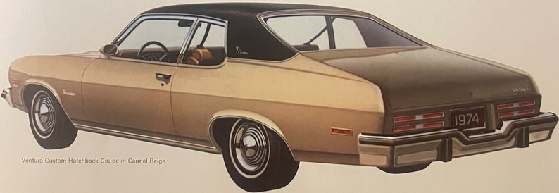 May include: A classic 1974 Ventura Custom Hatchback Coupe in caramel beige. The car has a black roof, chrome detailing, and a unique rear design with rectangular taillights. The image shows the car's side profile.