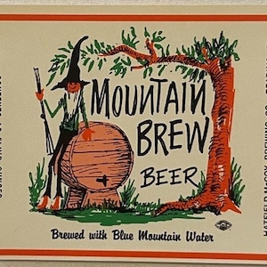 May include: A vintage beer label featuring a cartoon character with a green hat and a red beard sitting on a barrel. The label reads "Mountain Brew Beer" and "Brewed with Blue Mountain Water".