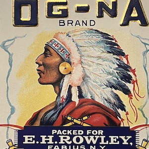 May include: Vintage illustration of a Native American man wearing a feathered headdress. The image is in a retro style and features the text "OG-NA BRAND" and "PACKED FOR E.H. ROWLEY, FABIUS, N.Y."
