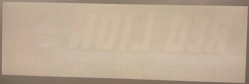 May include: White sticker with the word "REMARKABLE" printed in black.