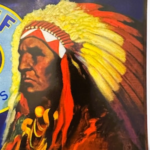 May include: A vintage painting of a Native American chief in profile, wearing a feathered headdress. The headdress features red, yellow, and white feathers. The portrait is set against a dark background with a partial view of text in the upper left corner.
