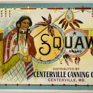 May include: Vintage label with the word "SQUAW" in large letters, featuring an illustration of a Native American woman in traditional attire. The label also includes the text "BRAND" and "DISTRIBUTED BY CENTERVILLE CANNING CO., CENTERVILLE, MD."