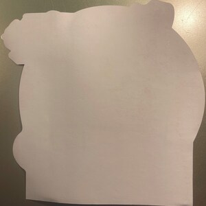 May include: A blank white card with a rounded edge and a decorative design at the top. The card is made of thick paper and has a smooth surface.