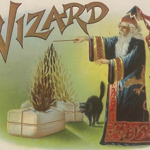 May include: A vintage illustration of a wizard with a long white beard and a blue robe, holding a wand and pointing it at a flame. The word "WIZARD" is written in gold letters above the wizard. A black cat sits in the foreground.