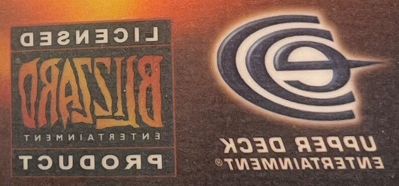 May include: A black and white logo for Upper Deck Entertainment with the text "Upper Deck" and a stylized "E" logo. The logo is on a brown background. The text "Licensed Blizzard Entertainment Product" is also visible in the image.