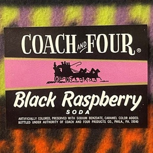 May include: A vintage label for Coach and Four Black Raspberry Soda. The label features a black silhouette of a horse-drawn carriage against a pink background. The text "COACH AND FOUR" is in white lettering on a black background. The text "Black Raspberry Soda" is in white lettering on a black background. The label also includes the text "ARTIFICIALLY COLORED, PRESERVED WITH SODIUM BENZOATE, CARAMEL COLOR ADDED. BOTTLED UNDER AUTHORITY OF COACH AND FOUR PRODUCTS CO., PHILA., PA. 19140."