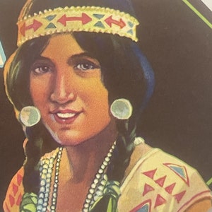 May include: A portrait of a woman with long dark hair wearing a beaded necklace, a headband with red and blue geometric patterns, and large white earrings. The background is dark green.