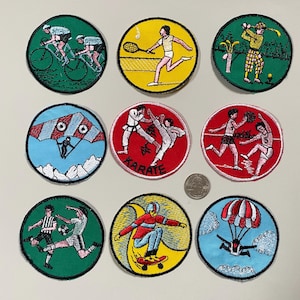 May include: Nine round embroidered patches depicting various sports and activities. The patches are colourful and feature images of people participating in activities such as cycling, tennis, karate, golf, skydiving, and football. The patches are approximately 2.5 inches in diameter.