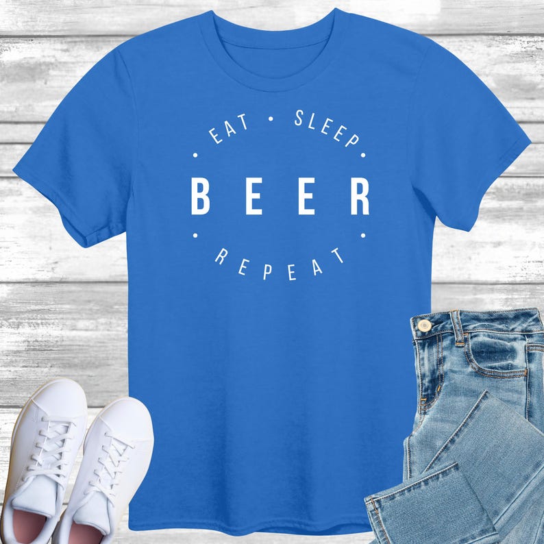 May include: A royal blue t-shirt with white text that reads "Eat. Sleep. Beer. Repeat."