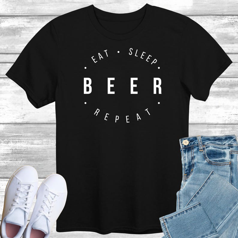 May include: Black t-shirt with white text that reads "Eat. Sleep. Beer. Repeat."