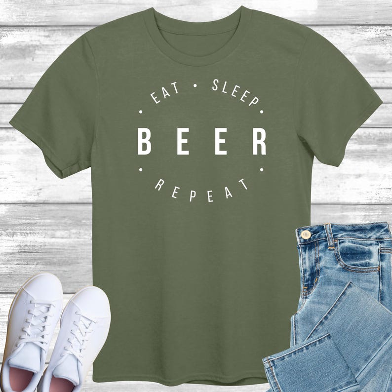 May include: A green t-shirt with white text that reads "Eat. Sleep. Beer. Repeat."