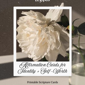 May include: A white floral card with the text "Affirmation Cards for Identity + Self-Worth" and "Printable Scripture Cards." The card is framed by a white border and features a large, white peony flower. The top left corner has the word "Dripped."
