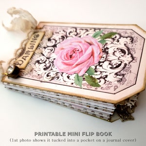 May include: A printable mini flip book with a pink rose and ornate design on the cover. The book is closed and has a decorative tag that says "Darling".