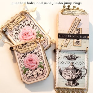 May include: A handmade scrapbook with a vintage aesthetic. The pages are decorated with floral patterns, lace, and paper ephemera. The scrapbook is bound with metal rings and has the words "Once Upon A Time" and "Darling" on the pages.