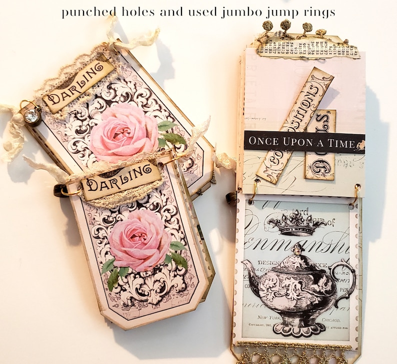 May include: A handmade scrapbook with a vintage aesthetic. The pages are decorated with floral patterns, lace, and paper ephemera. The scrapbook is bound with metal rings and has the words "Once Upon A Time" and "Darling" on the pages.