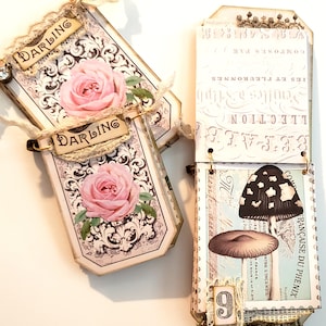 May include: Two decorative tags with a floral design and the word "Darling" on each. The tags are attached to a larger tag with a mushroom illustration and the text "FRAN&Ccedil;AISE DU PHENIX".